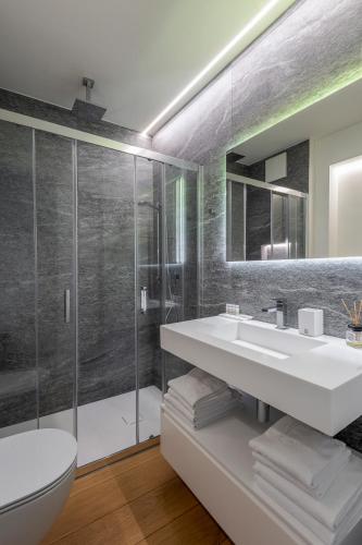 a bathroom with a toilet and a sink and a shower at Sasso Boretto, Luxury Holiday Apartments in Ascona