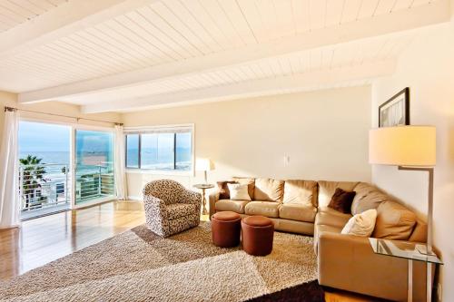 a living room with a couch and a table at Beautiful Views - Sand Section of Manhattan Beach 2 Bed/2 Bath in Manhattan Beach