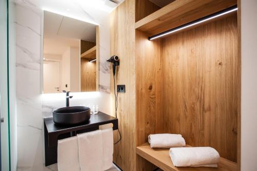 a bathroom with a sink and a mirror at Hotel Plaza Obradoiro by Bossh! Hotels in Santiago de Compostela