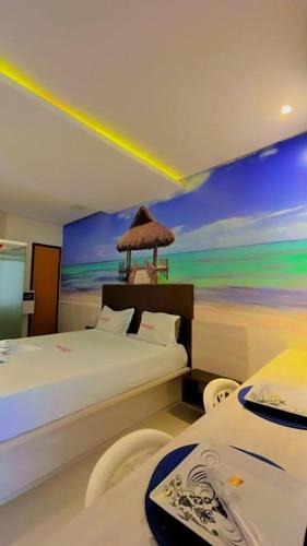 a bedroom with two beds and a painting on the wall at Motel Premium (Adults Only) in Barbalha