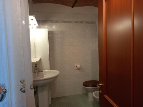 a bathroom with a sink and a toilet at La Casina di Veggio in Perugia