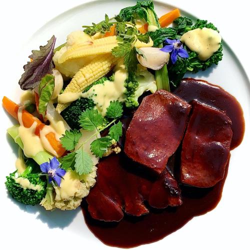 a white plate of food with meat and vegetables at Landhaus Hohly in Löwenstein