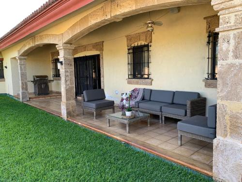 a patio with two couches and a table at Finca los Rosales in Parras de la Fuente