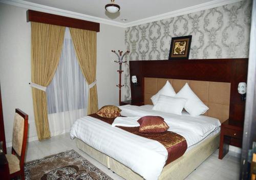 a bedroom with a bed with two pillows on it at الغبيشى بلازا in Jeddah