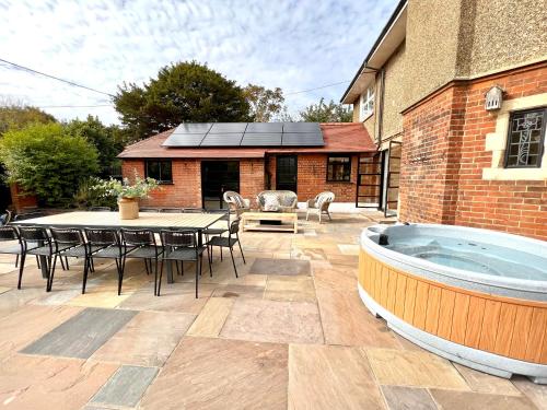 a patio with a table and a hot tub at Highview House Norfolk Coast - seaviews, beach, hot tub in Mundesley