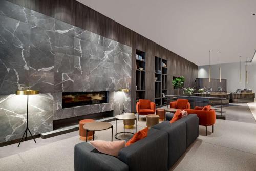 a living room with a couch and a fireplace at Radisson Blu Latvija Conference & Spa Hotel, Riga in Rīga