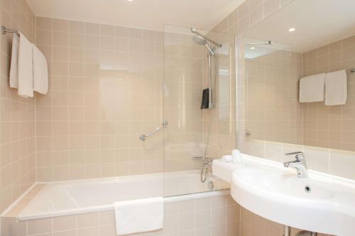 a bathroom with a tub and a sink and a shower at Radisson Blu Latvija Conference & Spa Hotel, Riga in Rīga