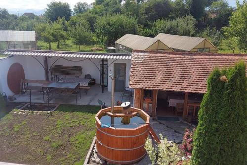 a small house with a table and a bench at Casa Nicholas in Zărneşti