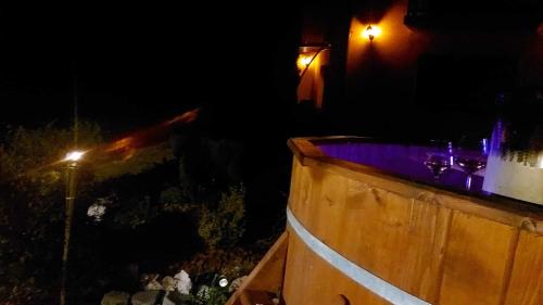 a wooden tub at night with a street light at Casa Nicholas in Zărneşti