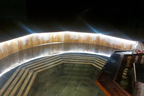a wooden tunnel with a pool of water at Casa Nicholas in Zărneşti