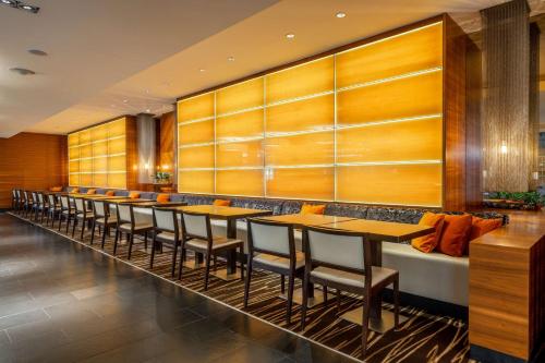 a long row of tables and chairs in a restaurant at Radisson Blu Elizabete Hotel, Riga in Rīga