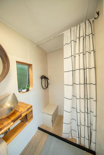a bathroom with a sink and a shower curtain at Caravana- Glamping Casa tortuga in La Nucía