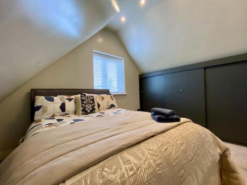 a bedroom with a large bed in a attic at Executive Boutique Holiday Home - CS in Southport