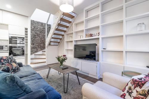 uma sala de estar com um sofá e uma mesa em London Choice Apartments - South Kensington - Mews House em Londres