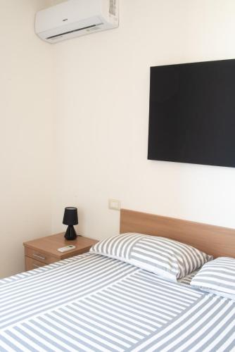 Ένα ή περισσότερα κρεβάτια σε δωμάτιο στο WEST SARDINIA APARTMENT 3
