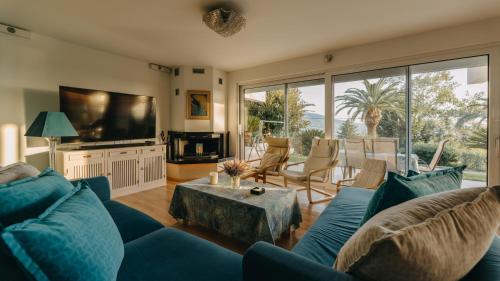 a living room with a blue couch and a table at Crystal Villa Patras in Patra