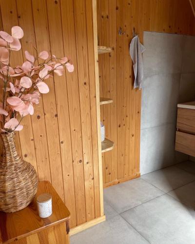 a bathroom with a vase with pink flowers on a table at Vrch Varta in Ružomberok