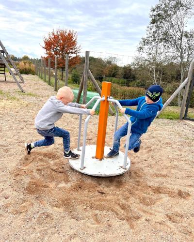 two young boys playing on a playground at Zeltāres in Jelgava