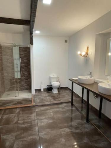 a bathroom with two sinks and a shower and a toilet at Santos Deluxe Apartment in Lisbon