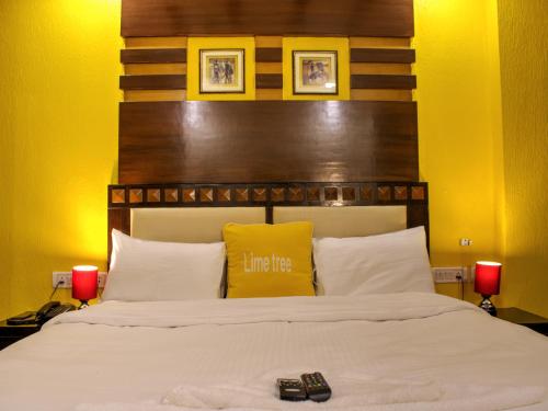 a bedroom with a large white bed with two red candles at Lime Stays B&B GK-2 at Greater Kailash Metro South Delhi nearby Saket Select City in New Delhi