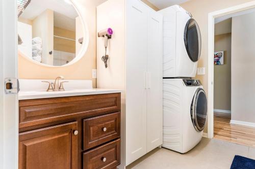 a bathroom with a washer and dryer next to a sink at LARGE 5 Bed Lake Geneva Home 4 Blocks from Lake! in Lake Geneva