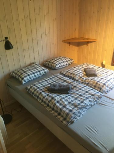 two beds in a room with a wall at Bed and Breakfast Hadeland in Harestua