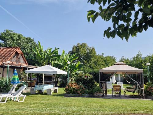 un grupo de sillas y sombrillas en un patio en Villa Dimitris, en Paralia Panteleimonos