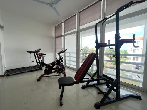a gym with two exercise bikes in a room at Villa164 - Luxo, Piscina e Ginásio à beira-mar in Santa Maria