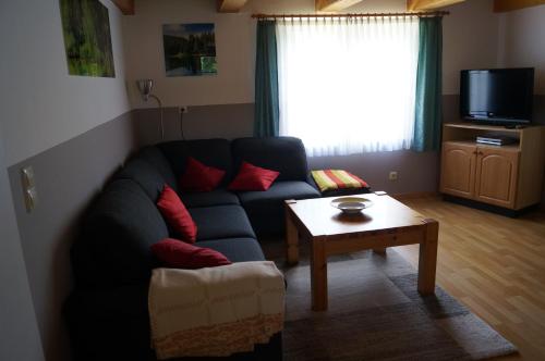 a living room with a couch and a table at Gutzeit in Ädelfors
