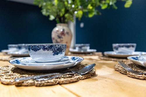 a wooden table with a blue and white cup and saucers at St Johns, Wakefield - Self check in & free parking in Wakefield