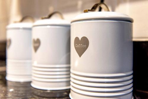 a row of white cups with a heart on them at St Johns, Wakefield - Self check in & free parking in Wakefield