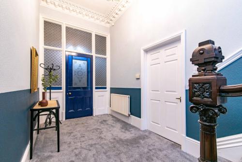 a hallway with a blue and white room with a door at St Johns, Wakefield - Self check in & free parking in Wakefield