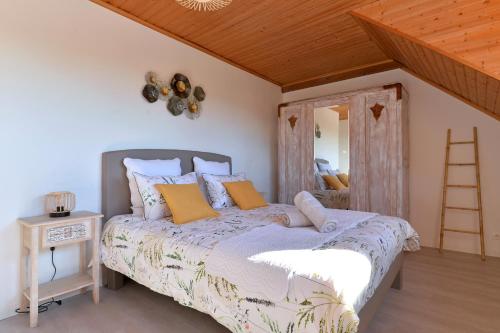 a bedroom with a bed and a wooden ceiling at AU GRE DES SAISONS in Thannenkirch