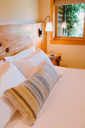 a blanket laying on a bed with a window at Sakura Ridge Farm & Lodge in Hood River