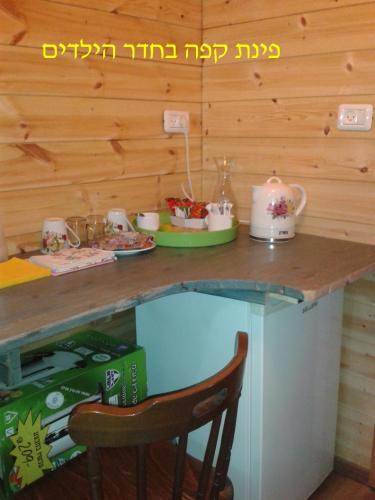 a kitchen with a counter with a table with tea pots at Country lodging in Manot in Manot
