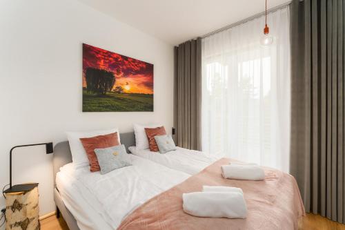 a bedroom with two beds and a large window at Apartament WILLOW TREE SurfingBird Dźwirzyno in Dźwirzyno