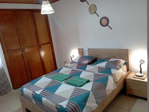 a bedroom with a bed with a colorful comforter at Apartamento Hogar Caribeño 2H con AA in Santa Marta