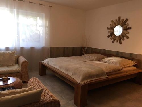 ein Schlafzimmer mit einem Bett, einem Sofa und einem Spiegel in der Unterkunft FeWo Khuki in Leipzig