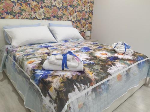 a bed with a blanket and two stuffed animals on it at Shine Flowers Room in Scordia