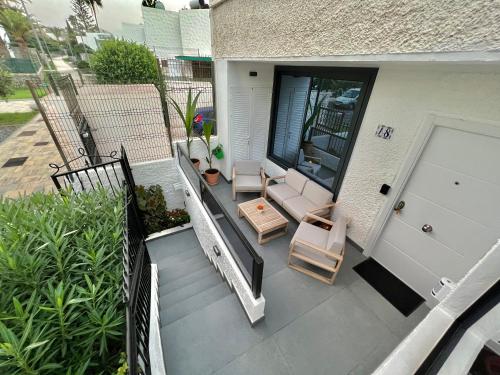 a balcony with two chairs and a porch with a door at Silver & Brownie, Nuevo apart cerca de la Playa in Playa de las Americas