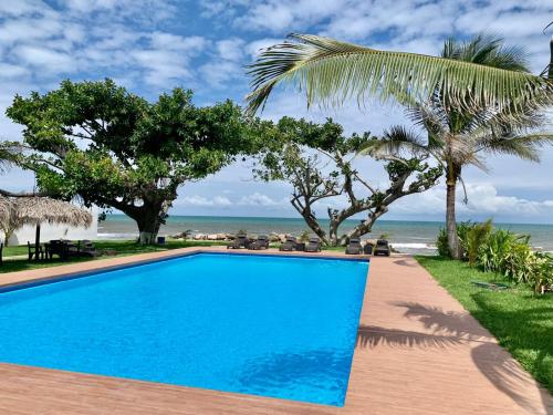 a blue swimming pool next to the beach at Mar De Estrellas - Hotel in Costa Esmeralda