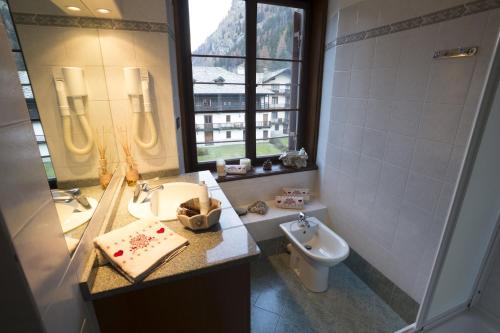 a bathroom with a sink and a toilet at Residence Blumental in Gressoney-Saint-Jean