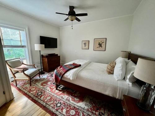 a bedroom with a bed and a fan and a chair at Hill Farm Inn - Manchester in Sunderland