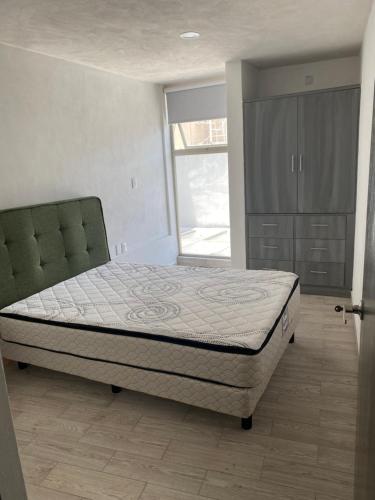 1 dormitorio con cama y ventana grande en Hermoso Departamento cerca Foro Sol, en Ciudad de México