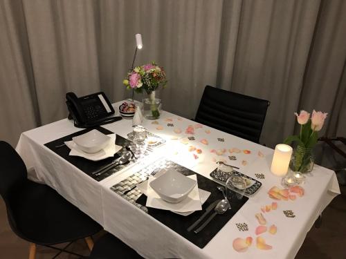 a table with a white table cloth and flowers on it at Antwerp Business Suites in Antwerp