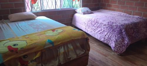 Cama o camas de una habitación en HOSPEDAJE GRIMANEZA
