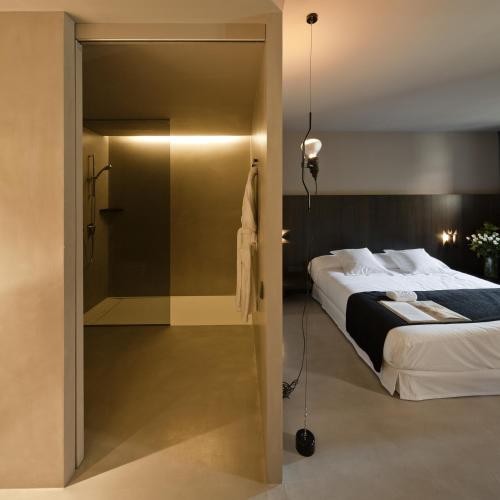 a bedroom with a bed and a sliding glass door at Caro Hotel in Valencia