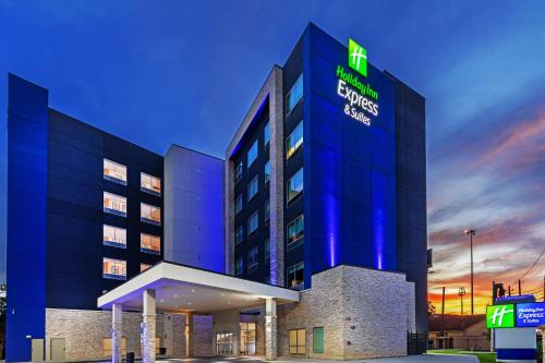 a hotel building with a lit up sign on it at Holiday Inn Express & Suites - Houston - Downtown North by IHG in Houston