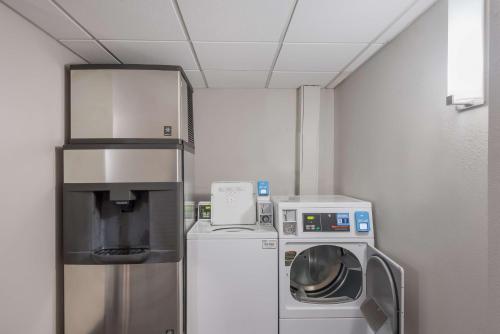 a laundry room with a washer and a refrigerator at Best Western Fort Wayne I-69 North in Fort Wayne