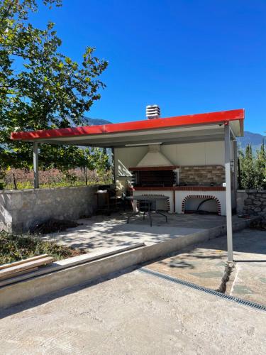a gas station with a red roof at Lovely village house in Polydrossos